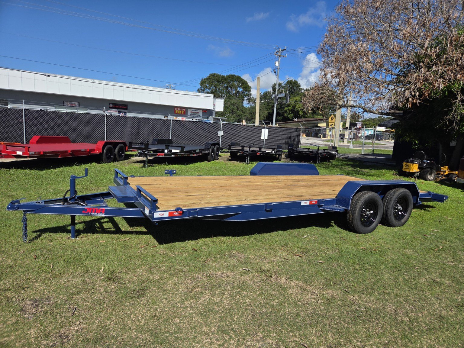 Blue tandem axle trailer with wood deck at Titan Trailer Sales
